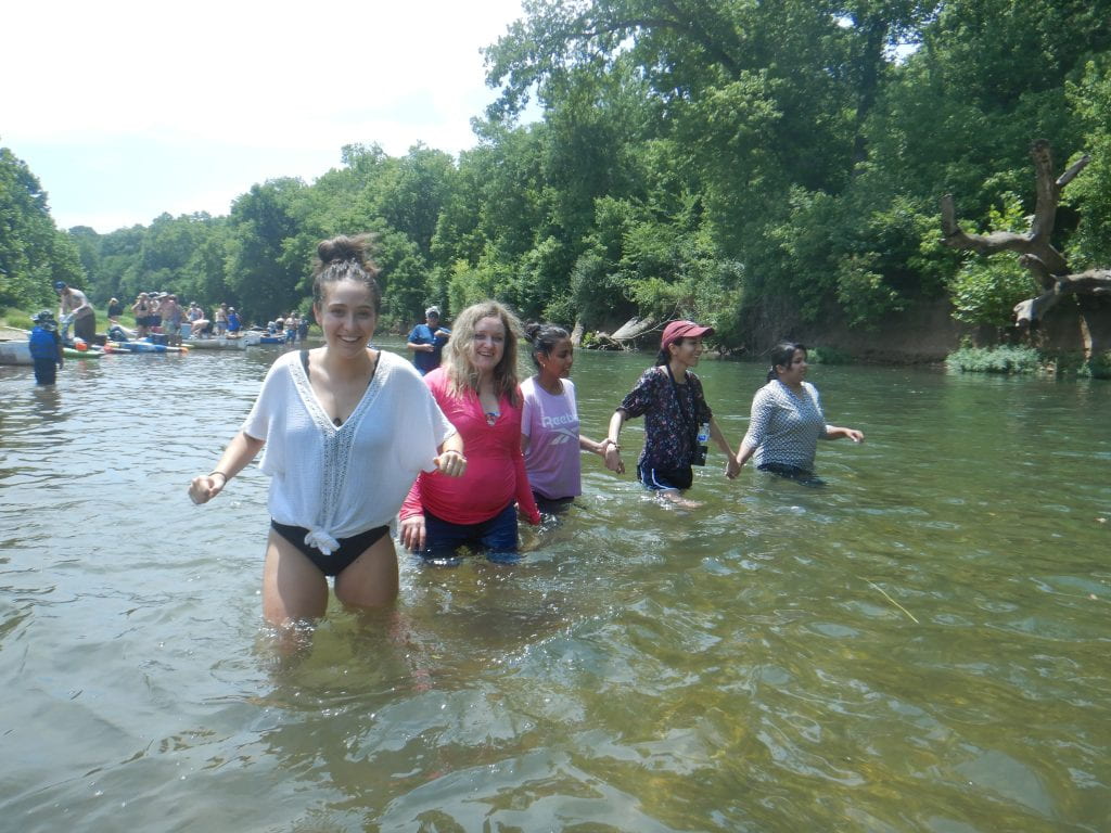 Lab members wading in river